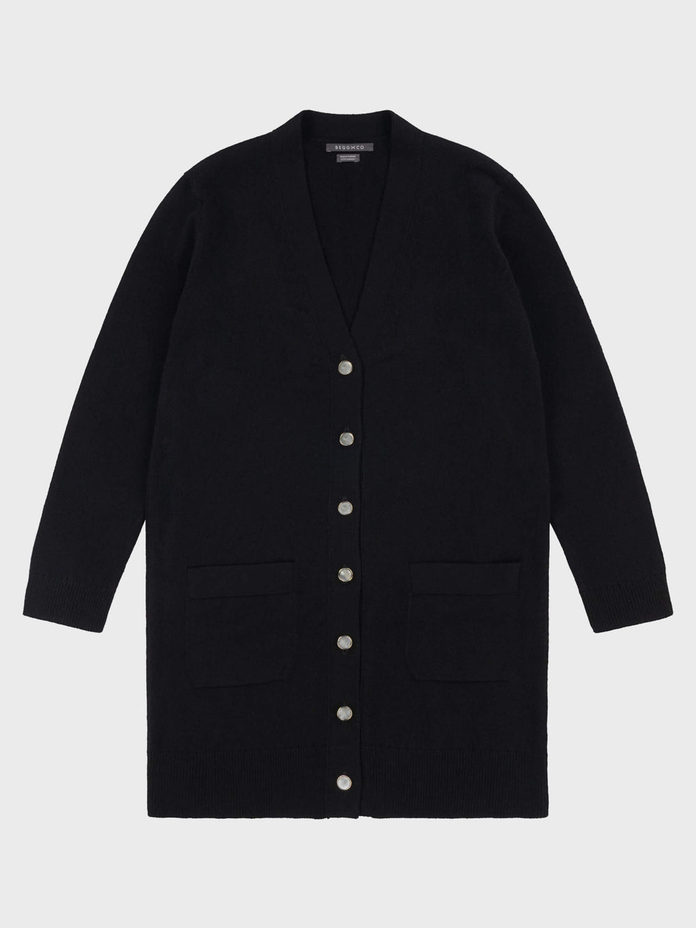 womens long black cashmere cardigan with pearl buttons and pockets on a grey background