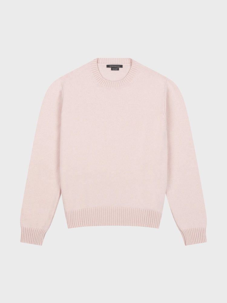 pale pink cashmere crewneck sweater on a grey background