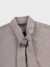 grey cashmere cape scarf neck detail on a grey background