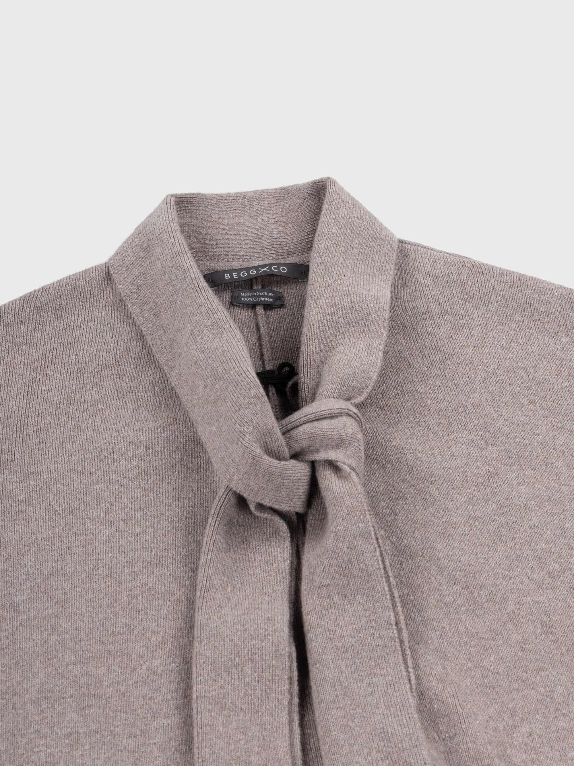 grey cashmere cape scarf neck detail on a grey background