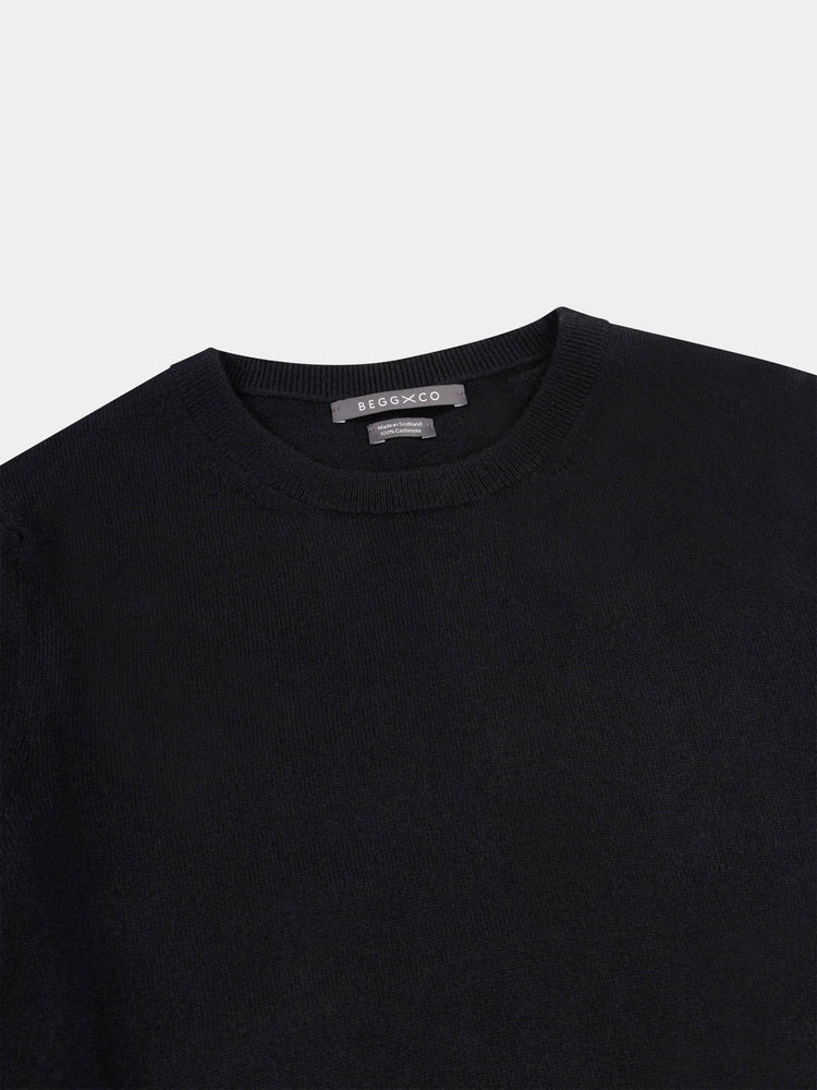 Black short-sleeve cashmere t-shirt on a light gray background