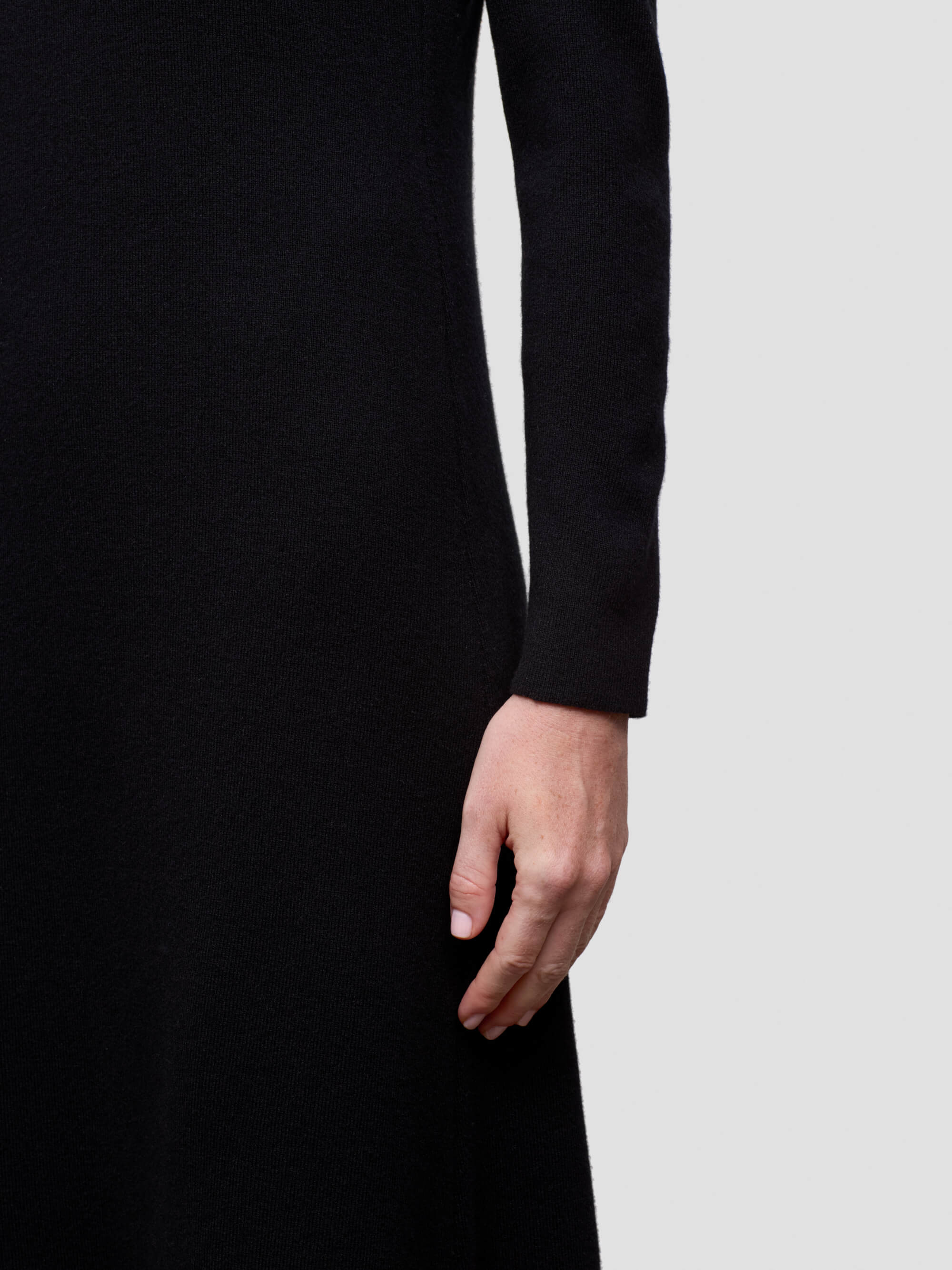 woman wearing cashmere dress on a plain background