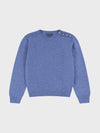 denim blue cashmere crew neck sweater with pearl button shoulder details on a grey background