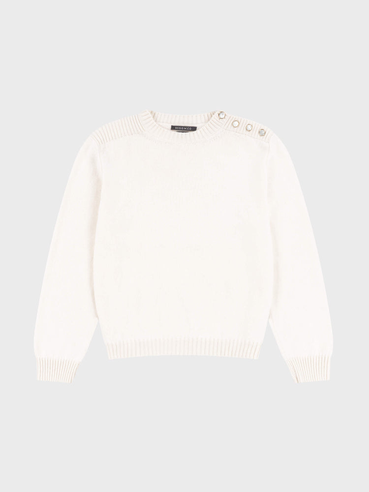 white cashmere crew neck sweater with pearl button shoulder details on a grey background