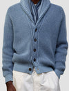 detail of a man wearing blue and navy ribbed cashmere cardigan with white shorts on a grey background