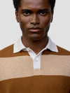 man wearing a striped brown and beige cashmere rugby shirt on a grey background
