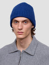 man wearing a blue ribbed cashmere beanie and grey ribbed zip sweater