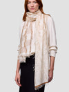 Woman wearing a beige cashmere silk scarf with a white background