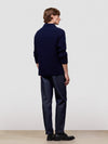 man wearing a navy blue cashmere zip sweater on a light gray background