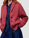 Woman wearing a red cashmere cardigan, blue dress on a white background
