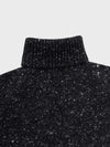 black chunky cashmere roll collar sweater with white speckles detail on a grey background