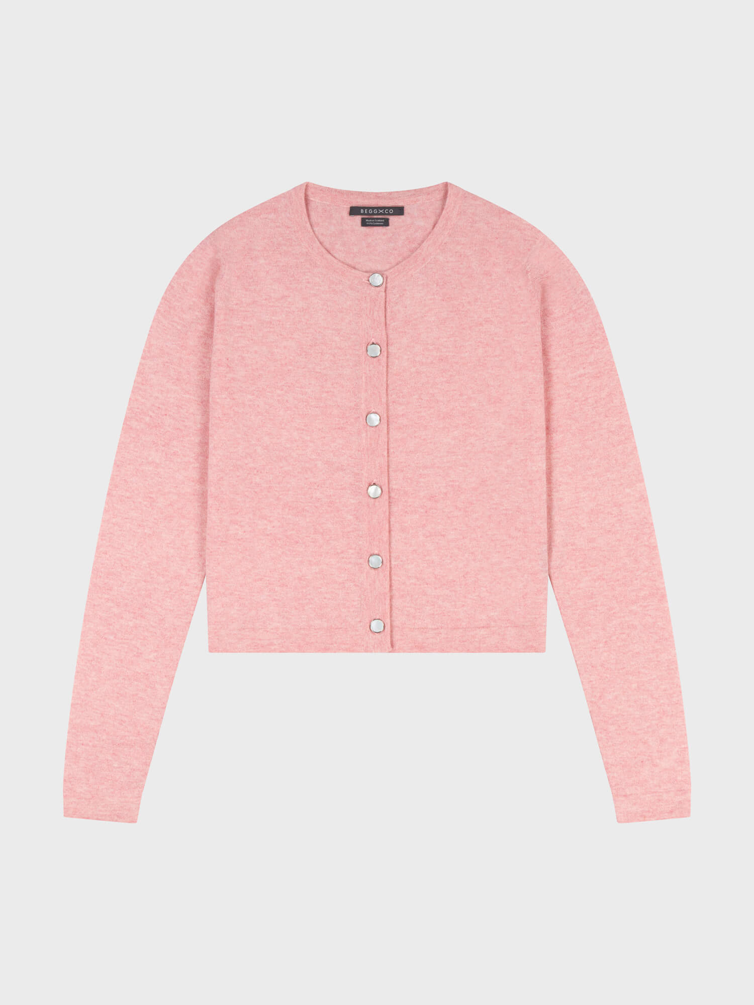 pink cashmere cardigan with pearl buttons on a grey background