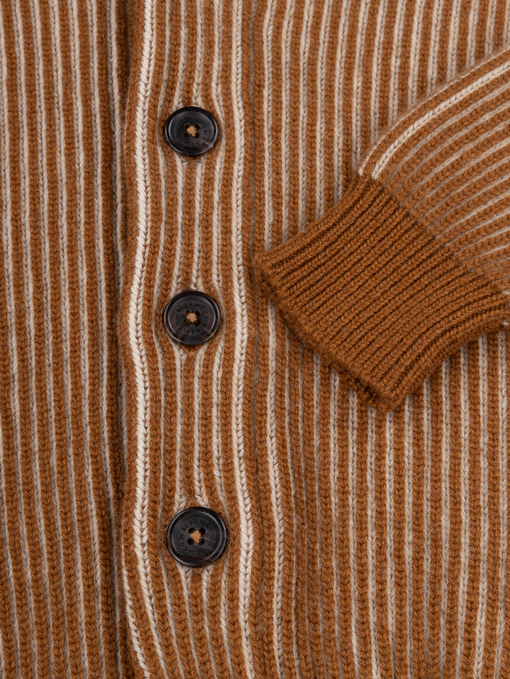 button and cuff detail of a brown and beige ribbed shawl collar cardigan