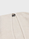 beige cashmere poncho neck detail on a grey background