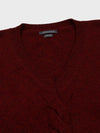 red cashmere v-neck sweater detail with cable knit detail down middle on grey background