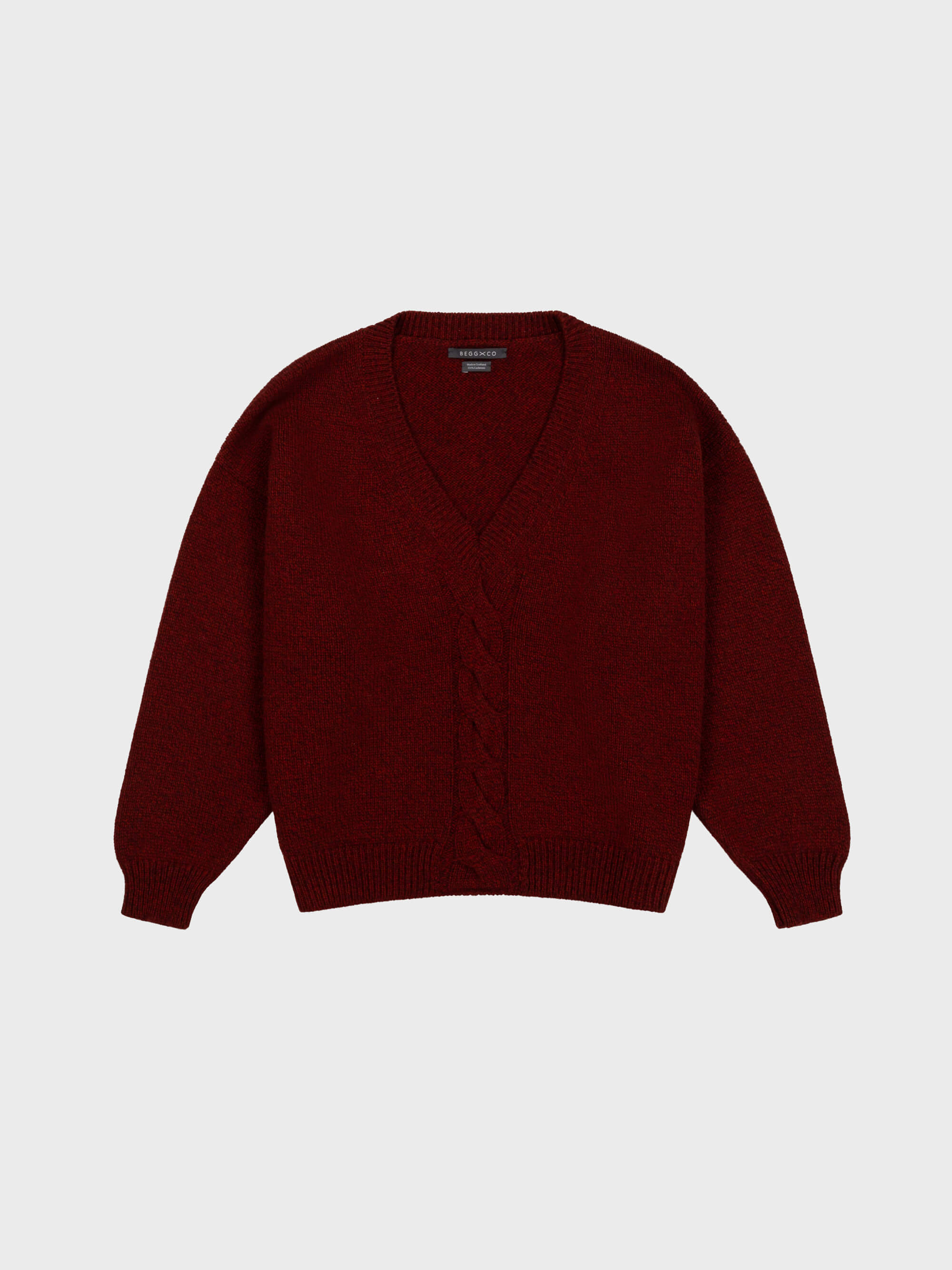 red cashmere v-neck sweater with cable knit detail down middle on grey background