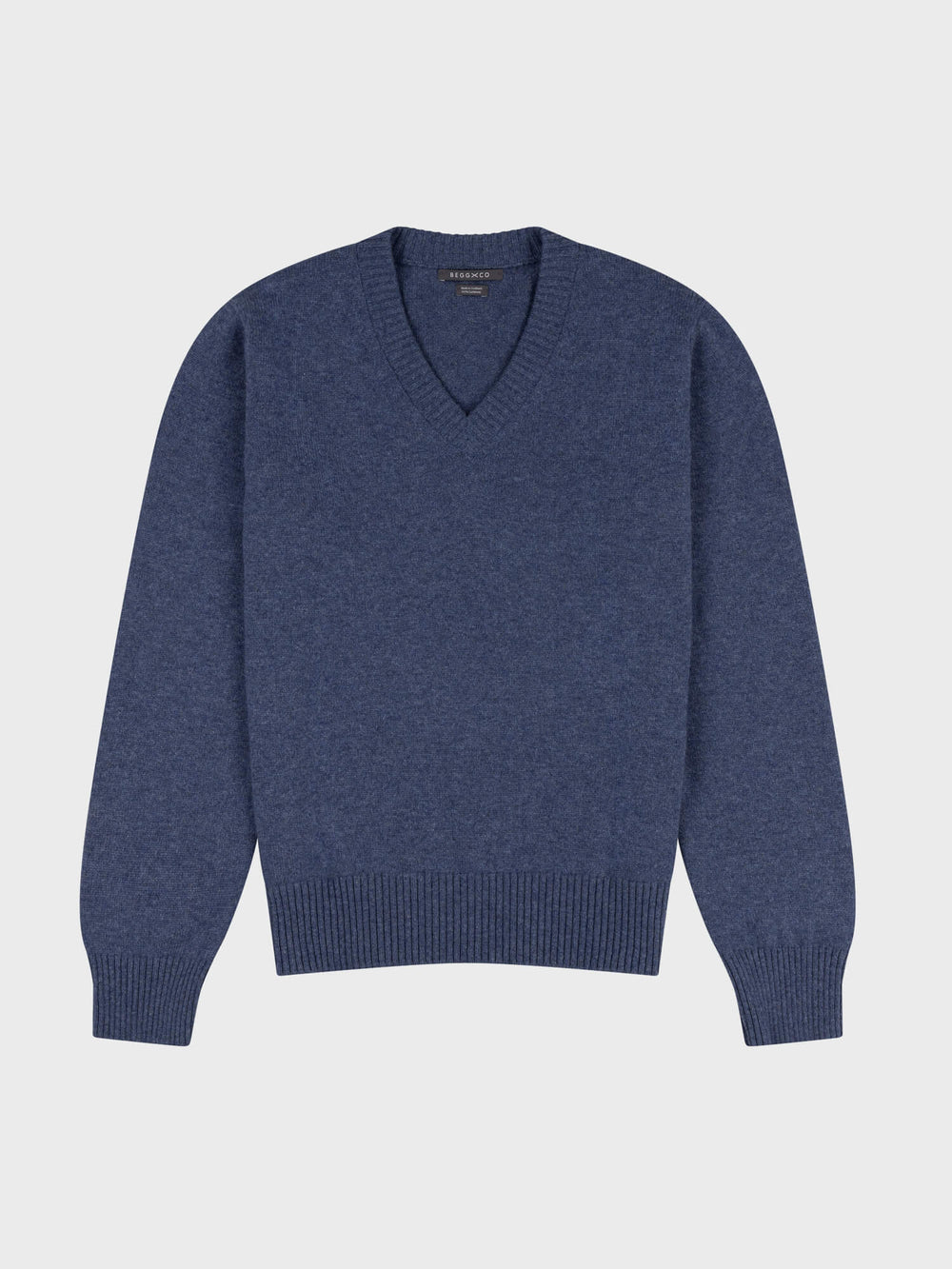 navy v-neck cashmere sweater on a grey background