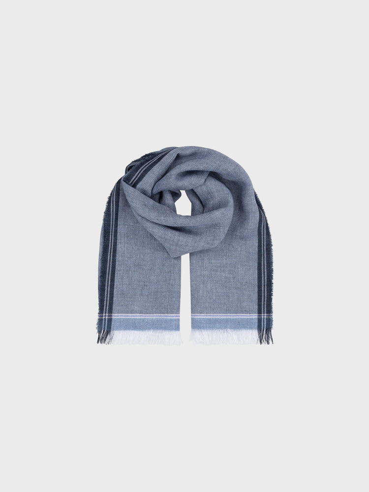 blue scarf with navy edges on a grey background