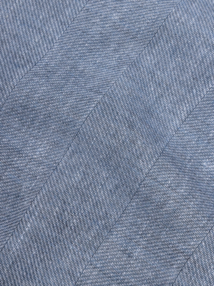 close up of a blue scarf with navy edges 