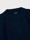marl navy blue chunky cable knit cashmere crewneck sweater detail on a grey background