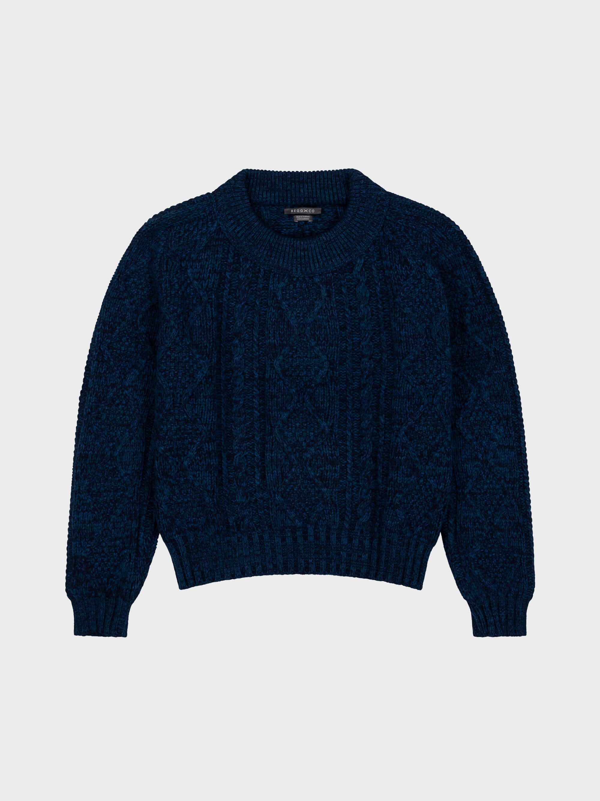 marl navy blue chunky cable knit cashmere sweater on a grey background