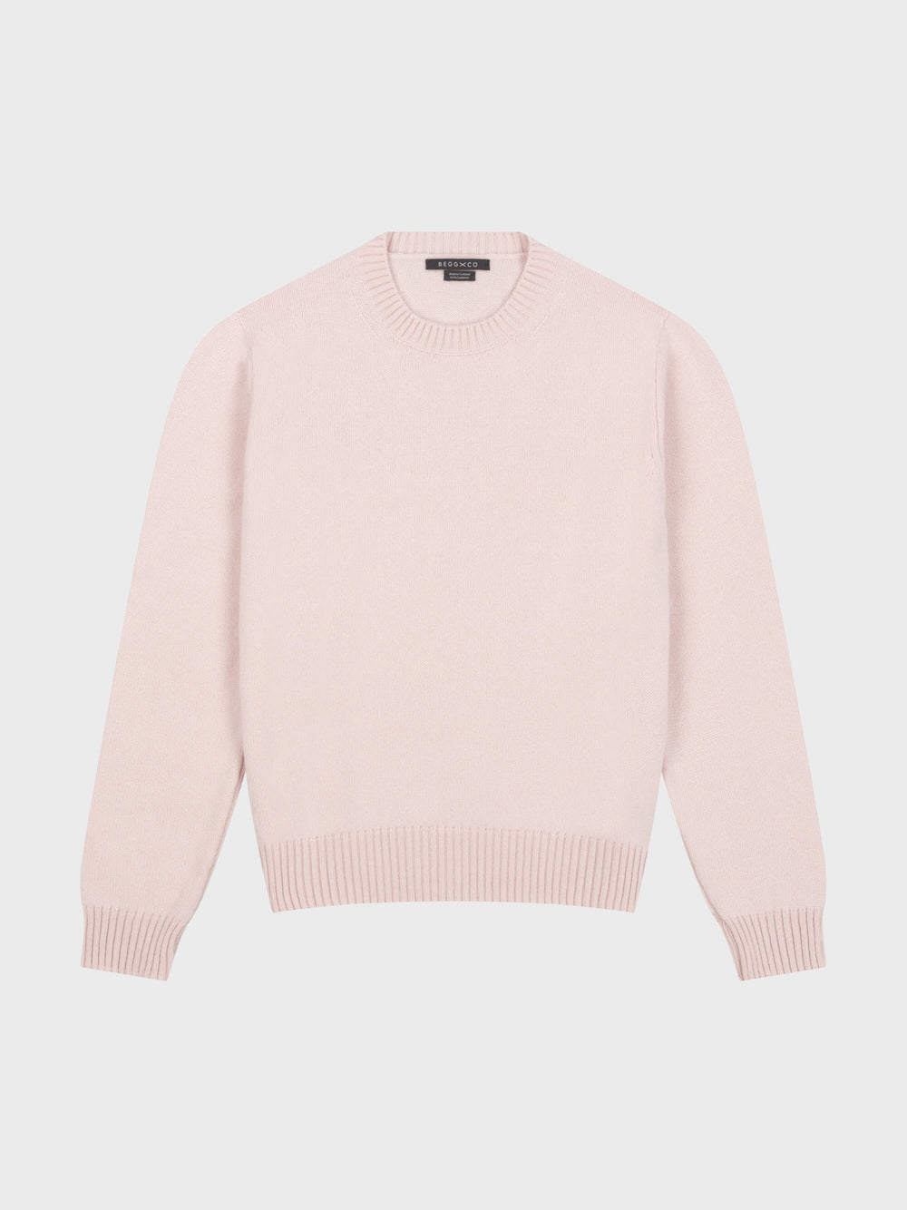 pale pink cashmere crewneck sweater on a grey background