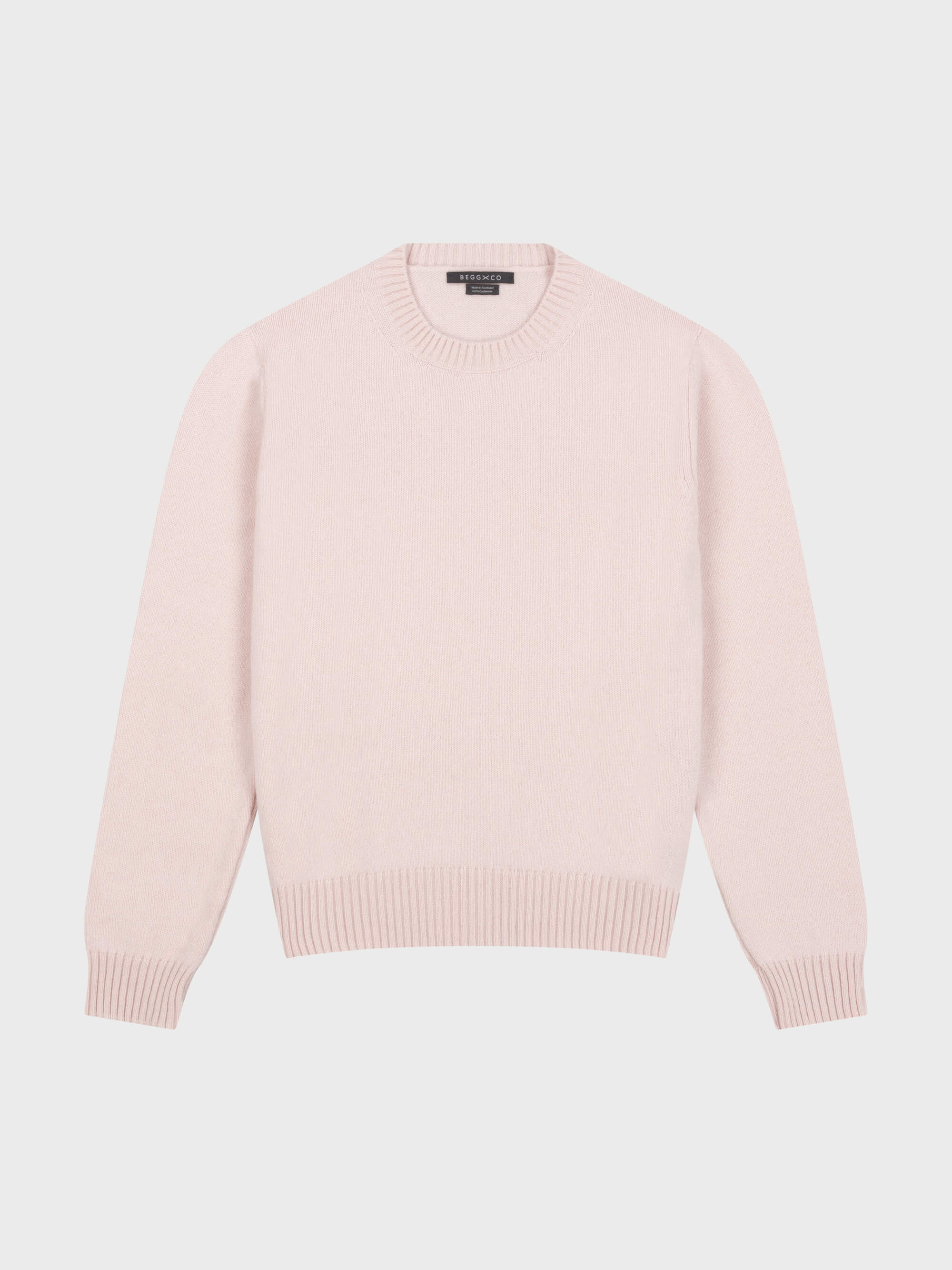 pale pink cashmere crewneck sweater on a grey background