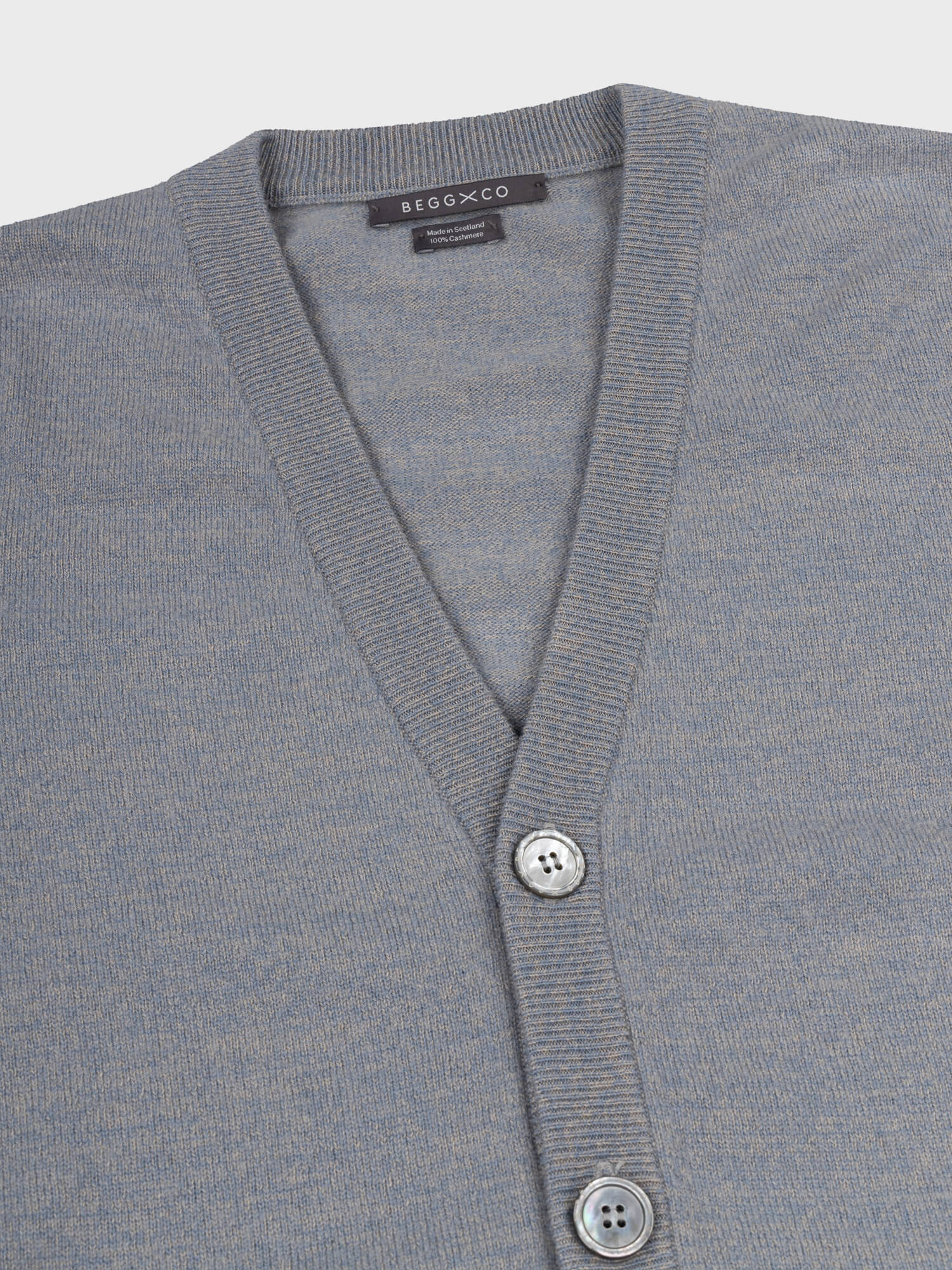 Gray cashmere cardigan with button details on a light gray background