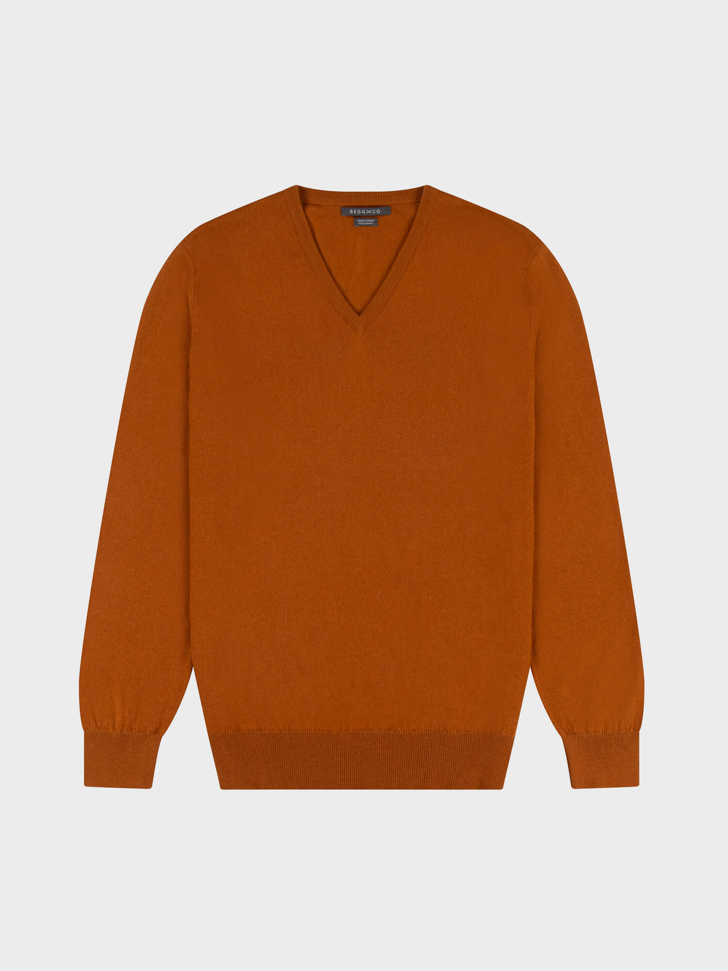brown cashmere v-neck sweater on a grey background