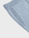 pocket detail of faded blue cashmere sweatpants on a grey background