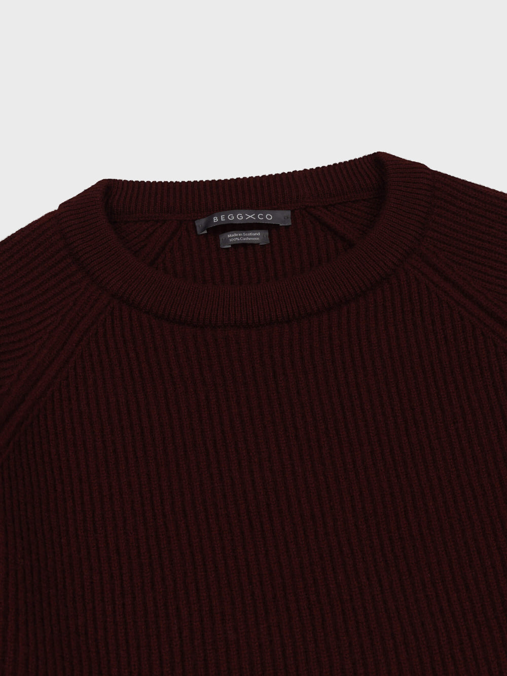 mens wine red cashmere crew neck ribbed sweater collar detail on a grey background