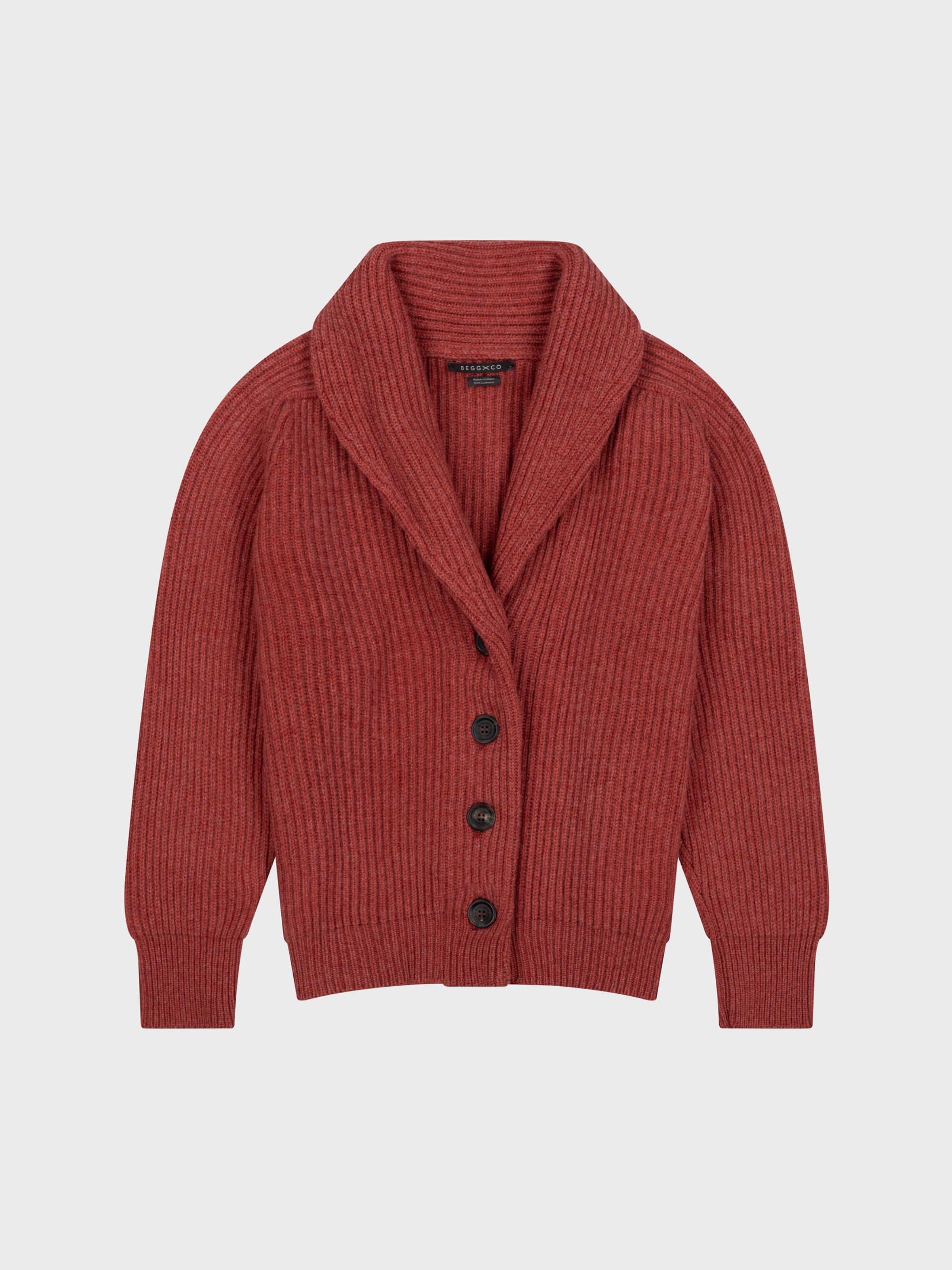 chunky ribbed red cashmere shawl collar cardigan with horn buttons on a grey background