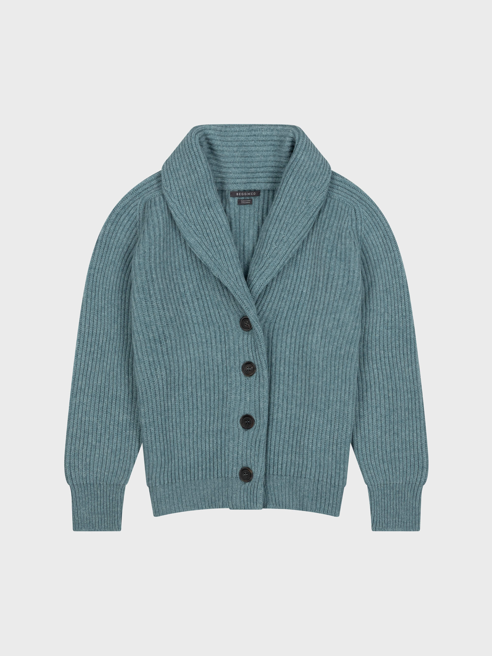 chunky ribbed green cashmere shawl collar cardigan with horn buttons on a grey background