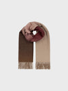 Multicolored pink and natural shade scarf with fringes on a light gray background