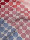 close up of a square scarf with blue, purple, pink and red spots