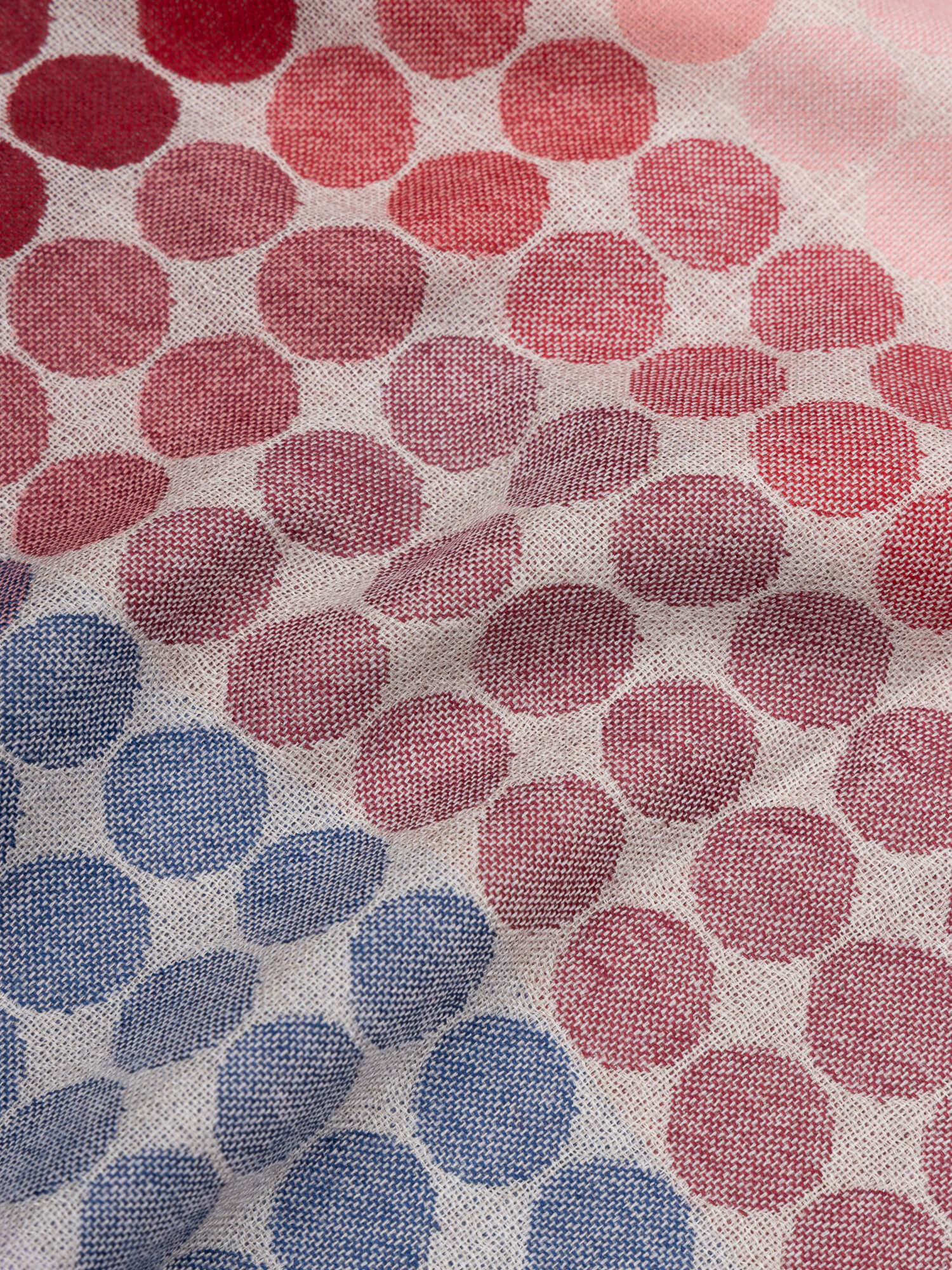 close up of a square scarf with blue, purple, pink and red spots