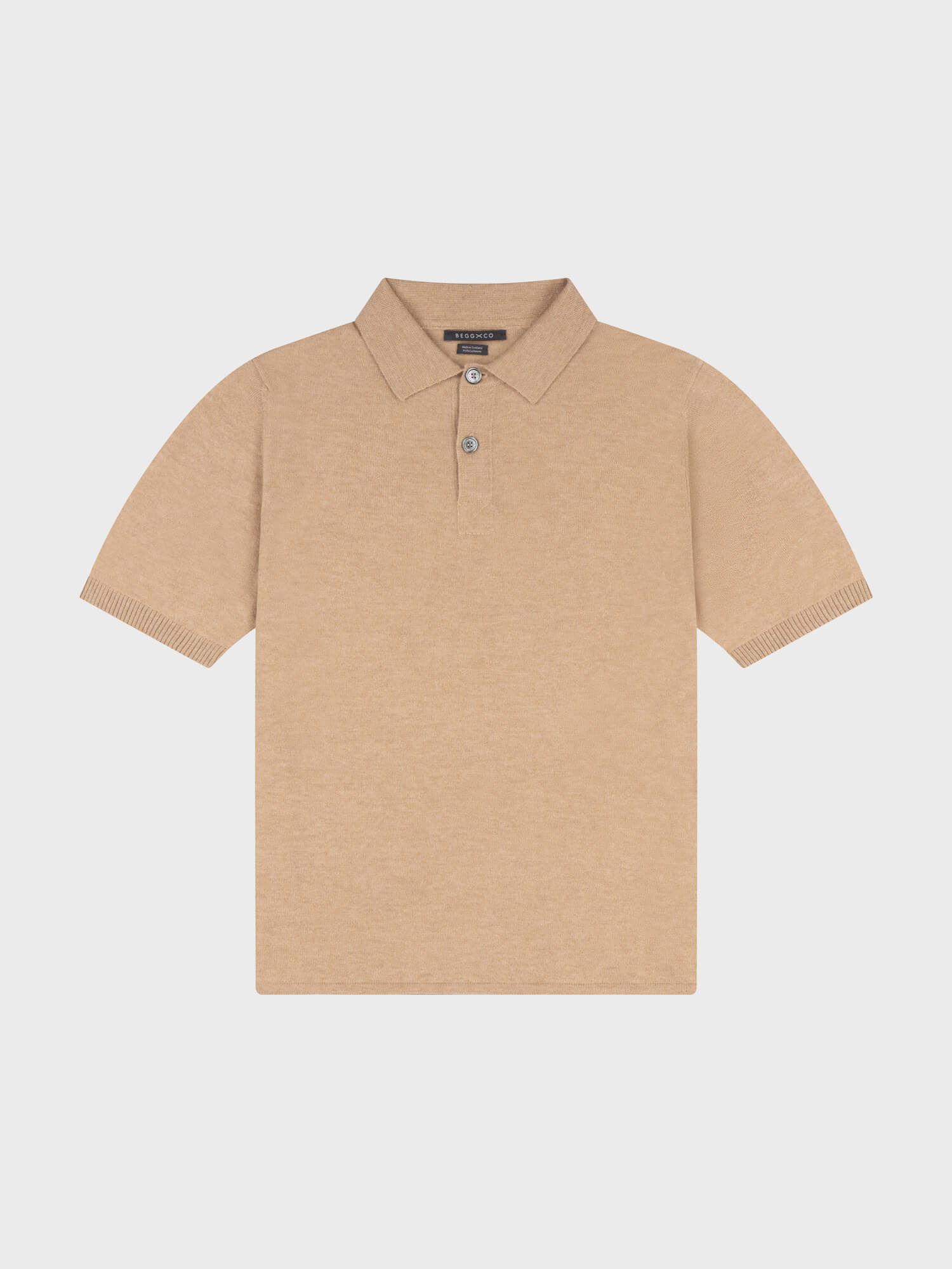 beige cashmere short sleeve polo on a grey background
