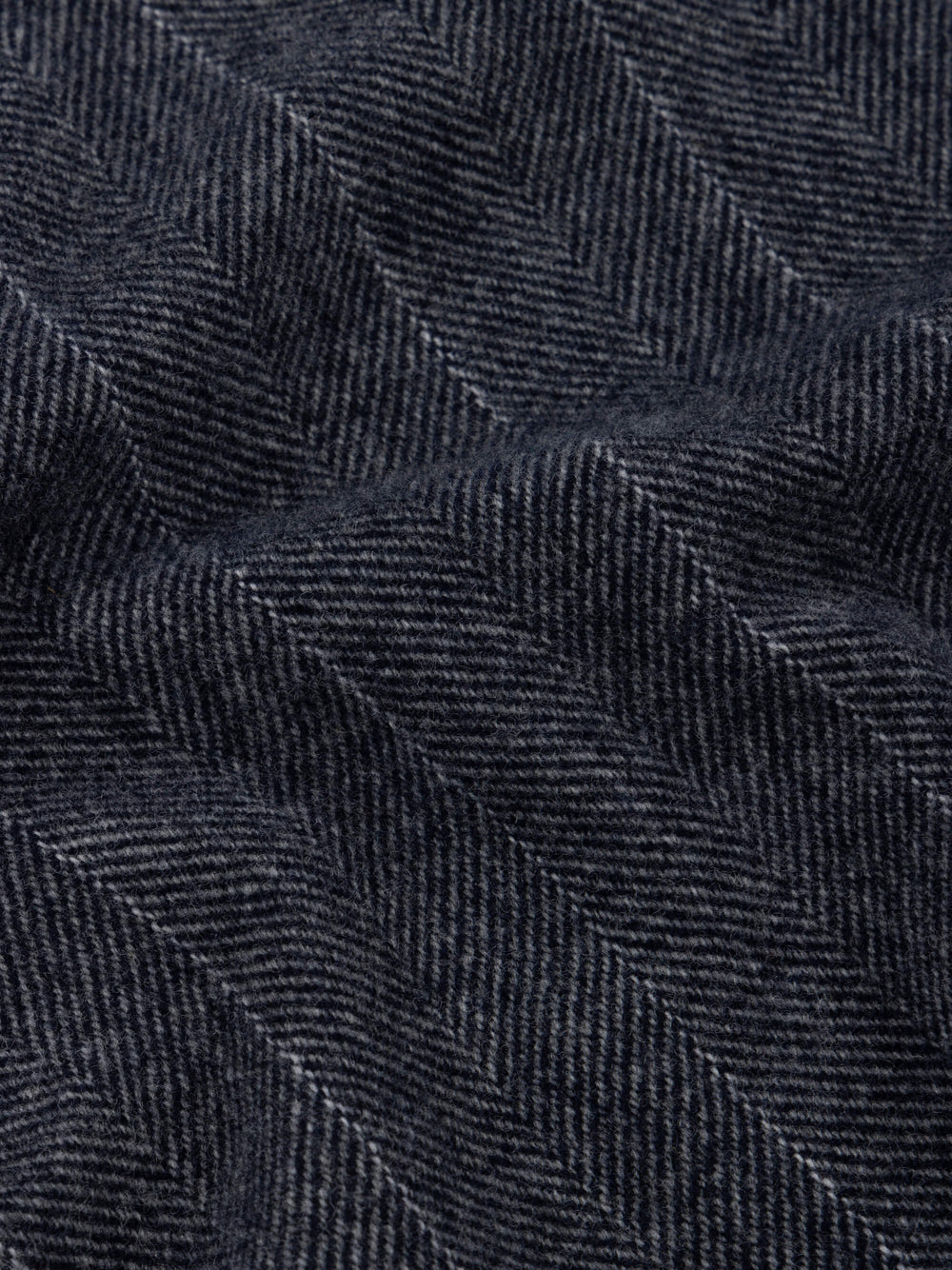 Close-up of dark blue scarf with a herringbone pattern