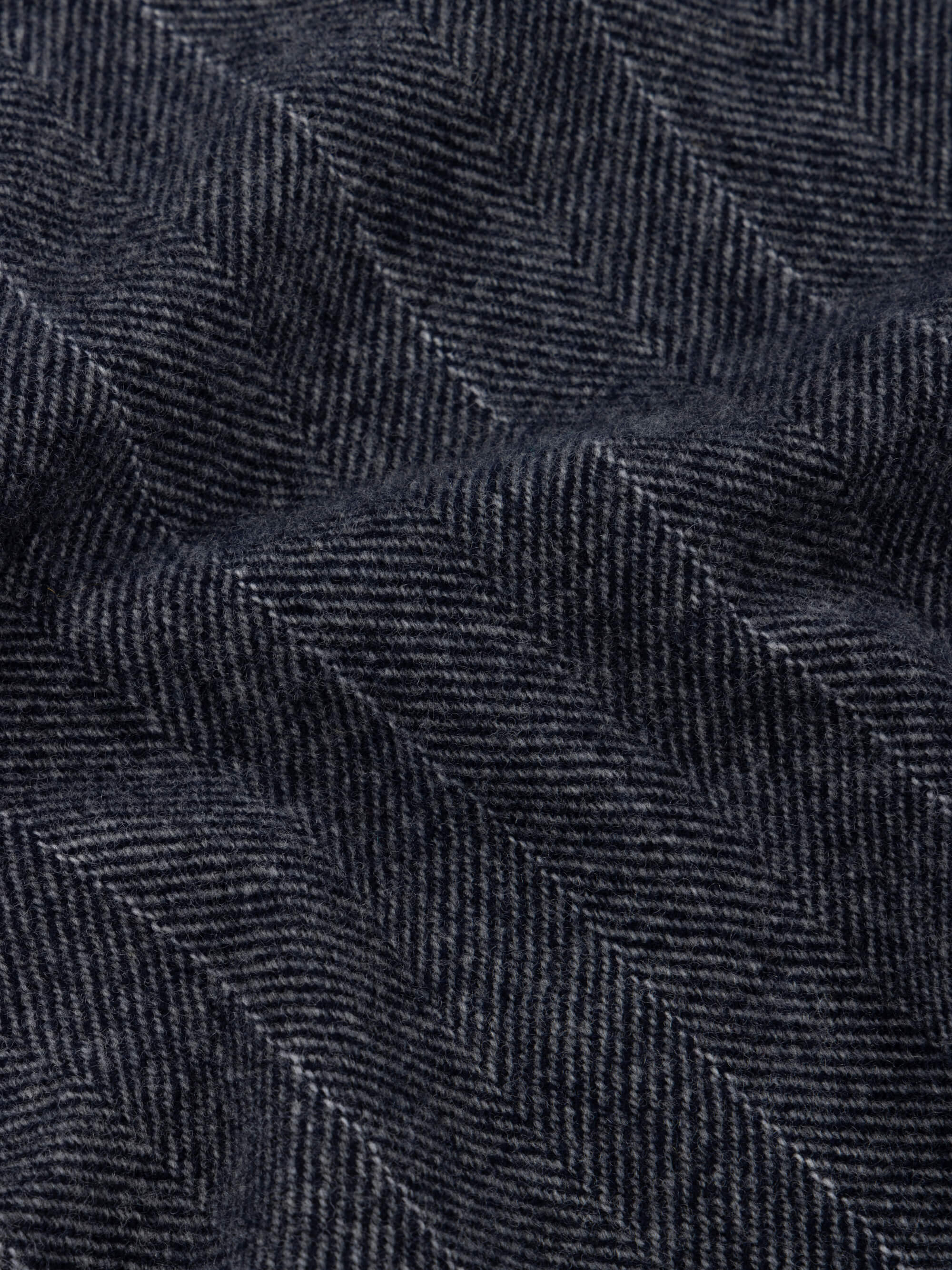 Close-up of dark blue scarf with a herringbone pattern