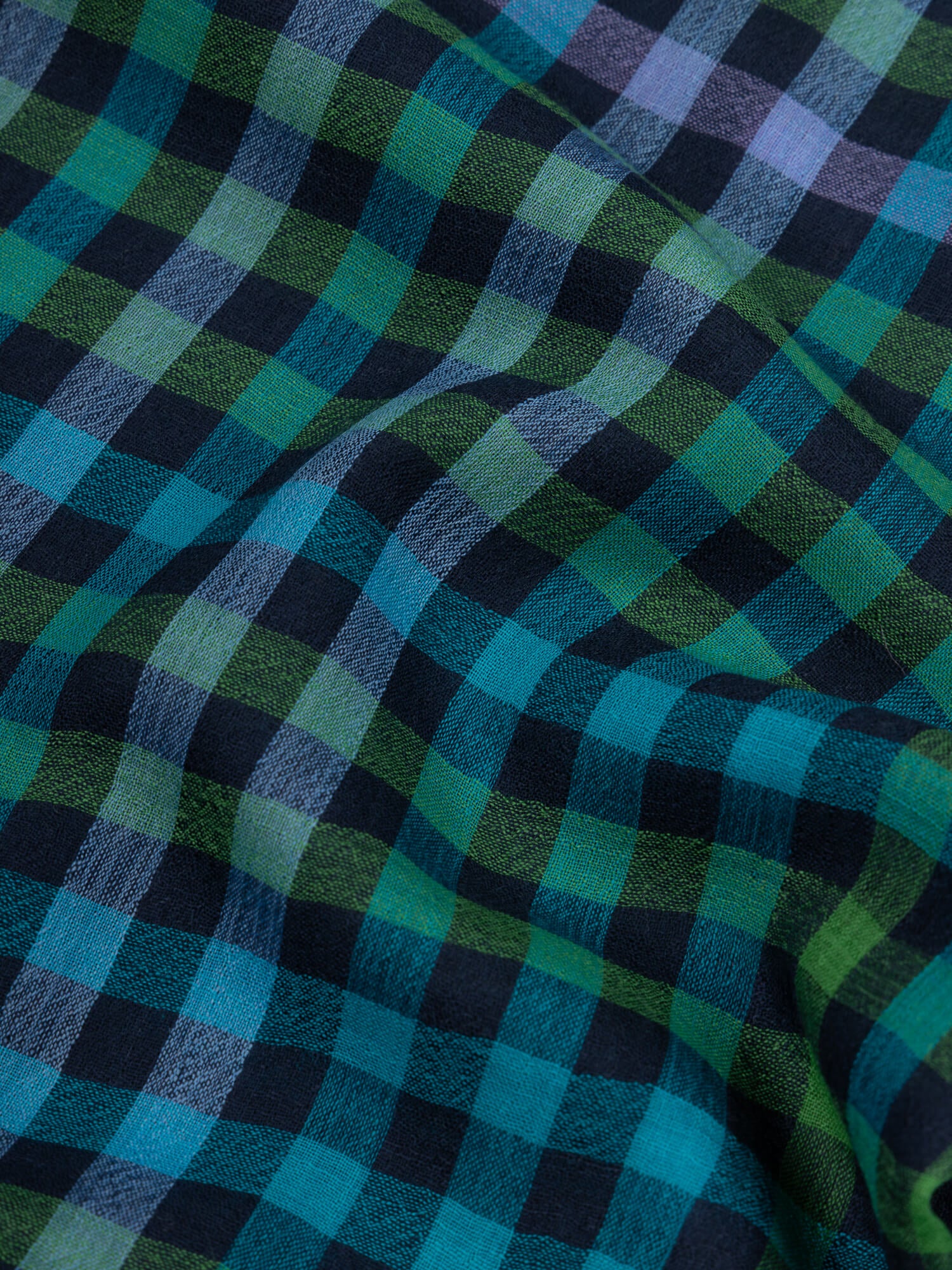 close up of a cashmere scarf with blue, green and purple checks