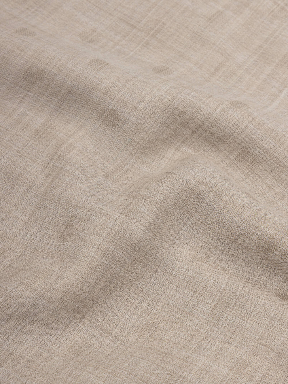 close up of a natural cashmere scarf with subtle polka dots