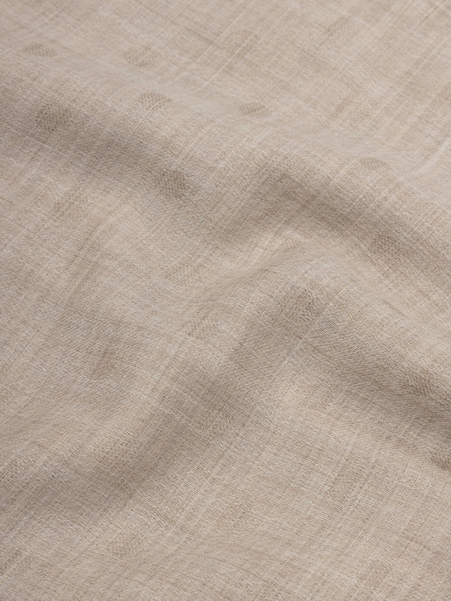 close up of a natural cashmere scarf with subtle polka dots