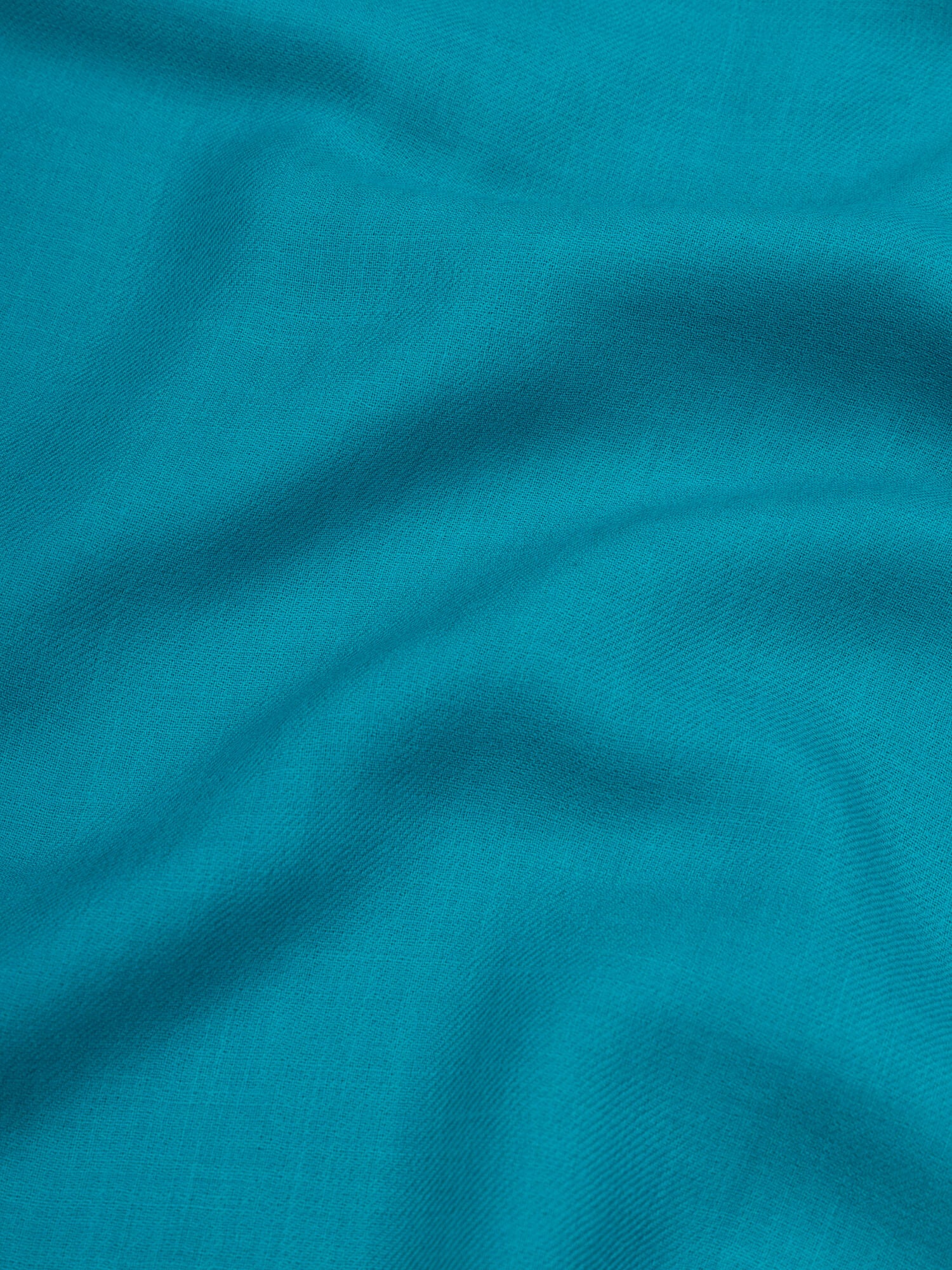 close up of a lightweight teal cashmere scarf