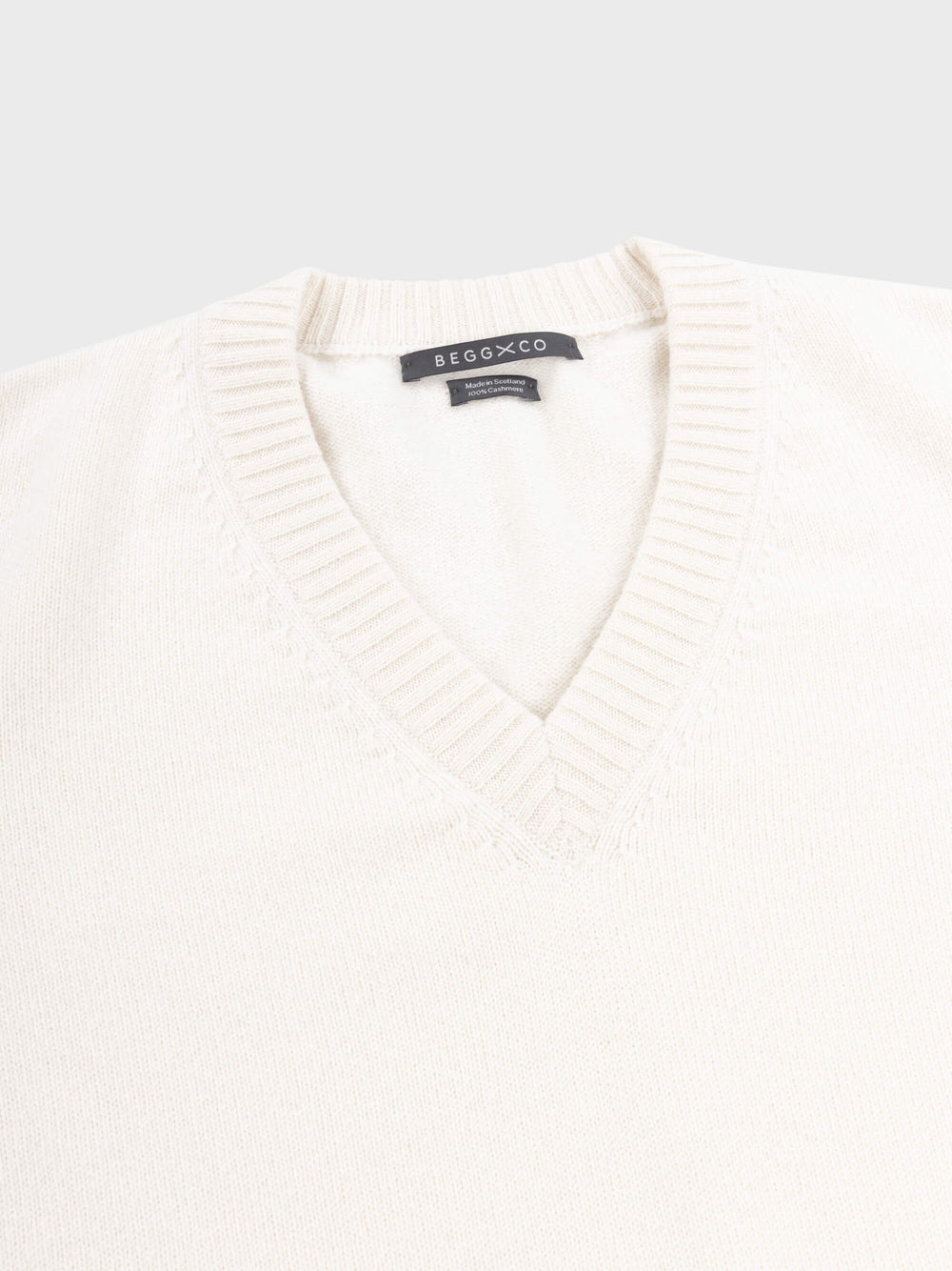 mens white vneck cashmere sweater on a grey background