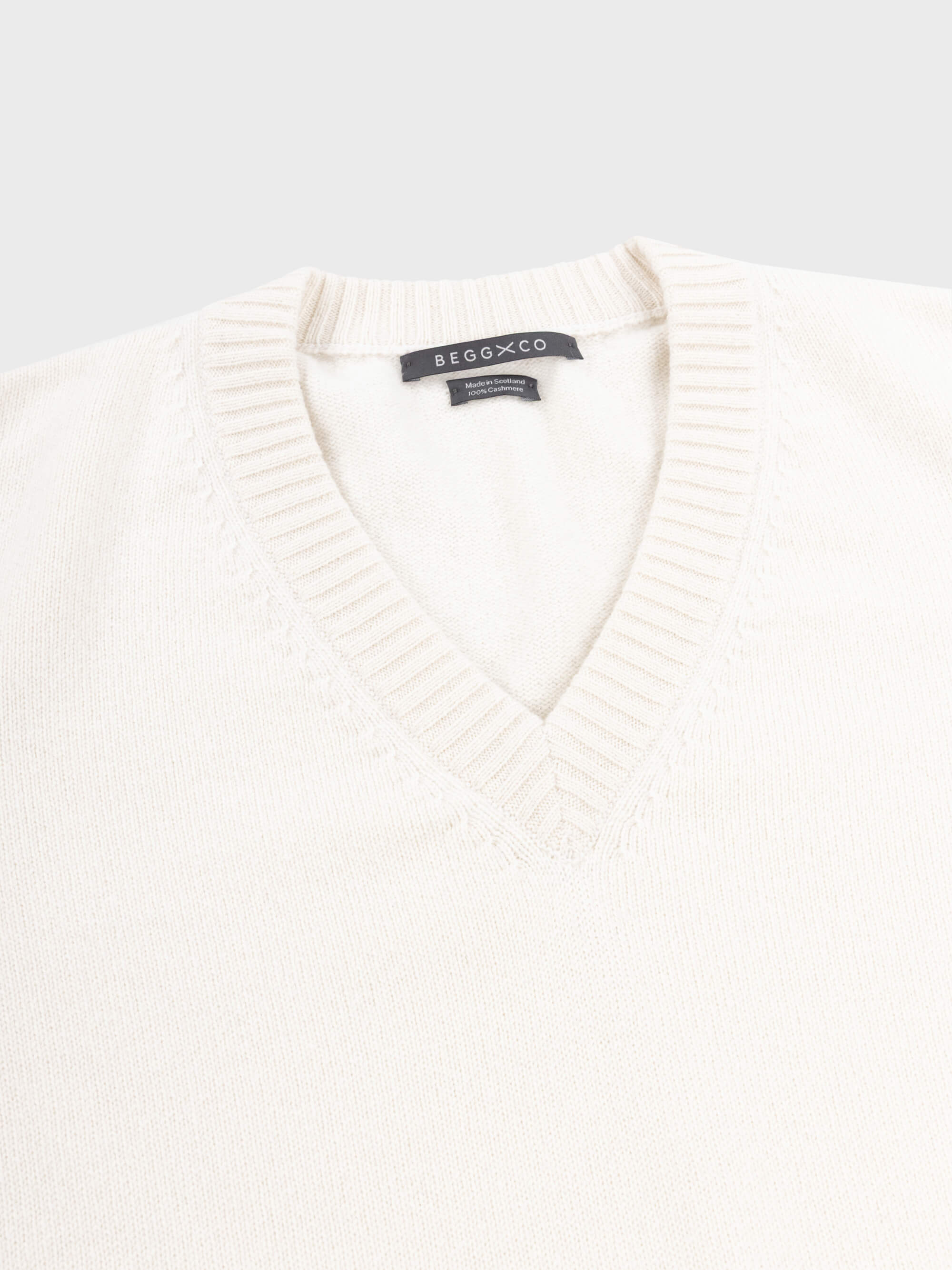 mens white vneck cashmere sweater on a grey background