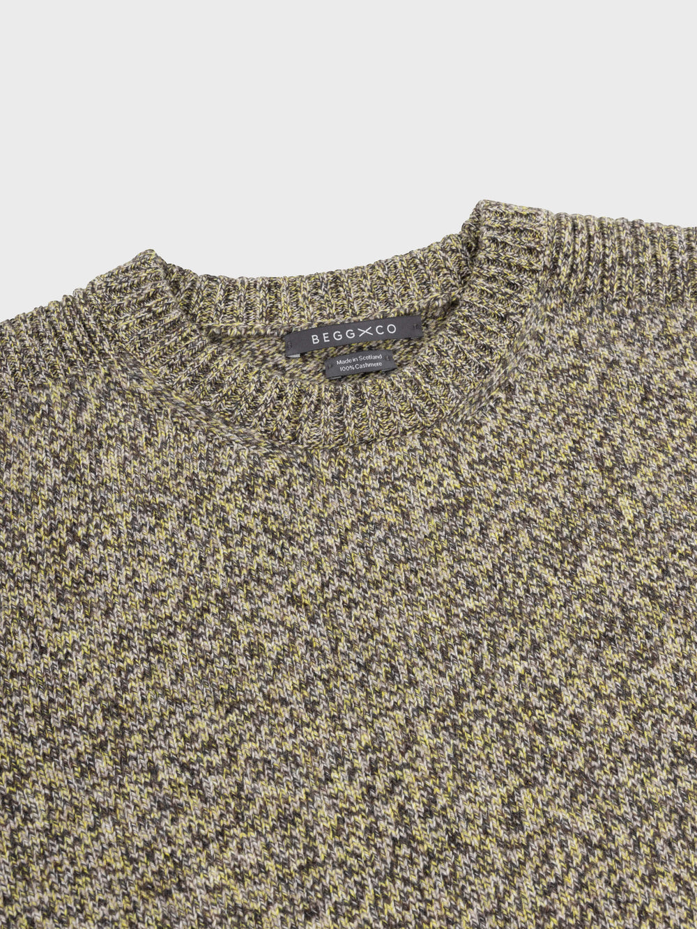 marl green and yellow cashmere crewneck sweater collar detail on a grey background
