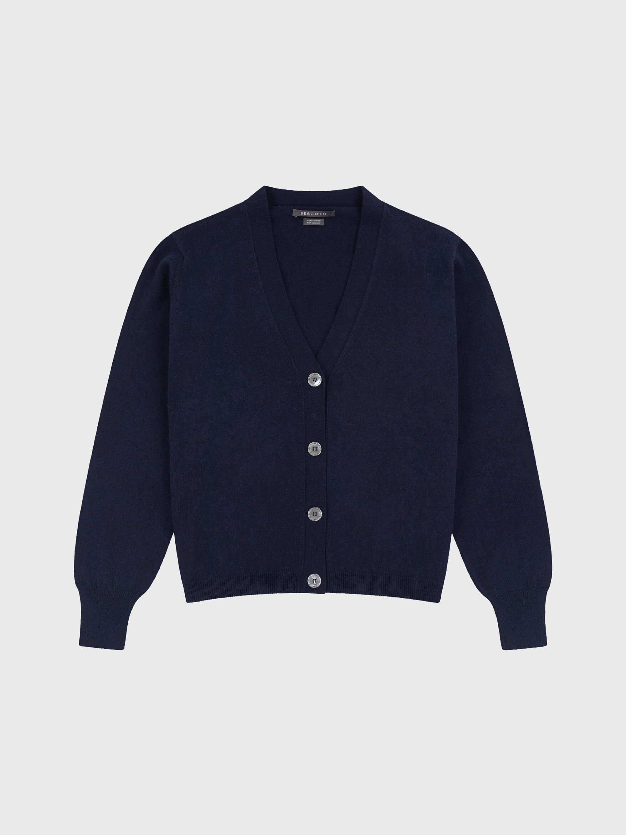 navy blue cashmere vneck cardigan with pearl buttons on a grey background