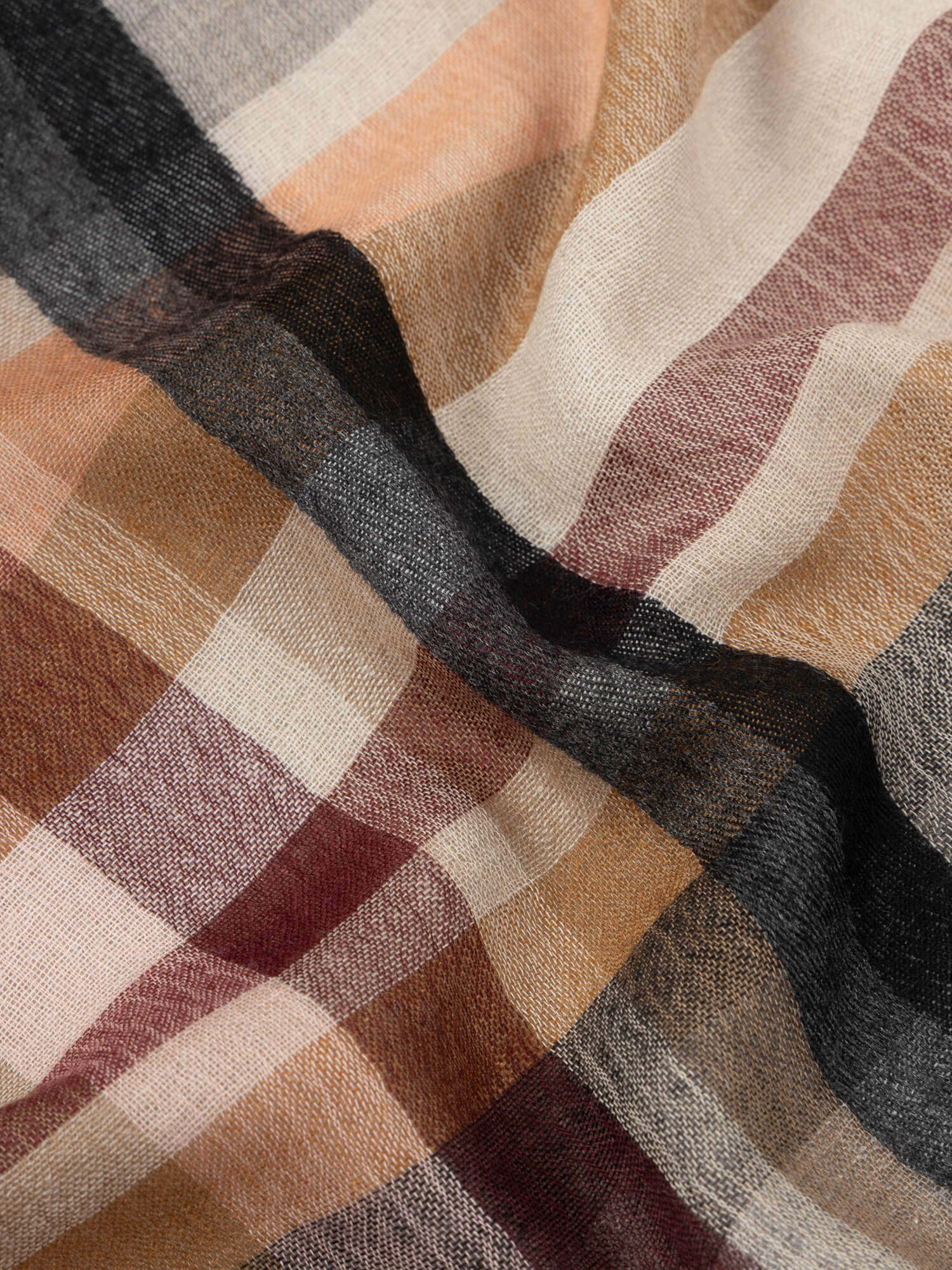 close up of a square scarf with orange and beige check