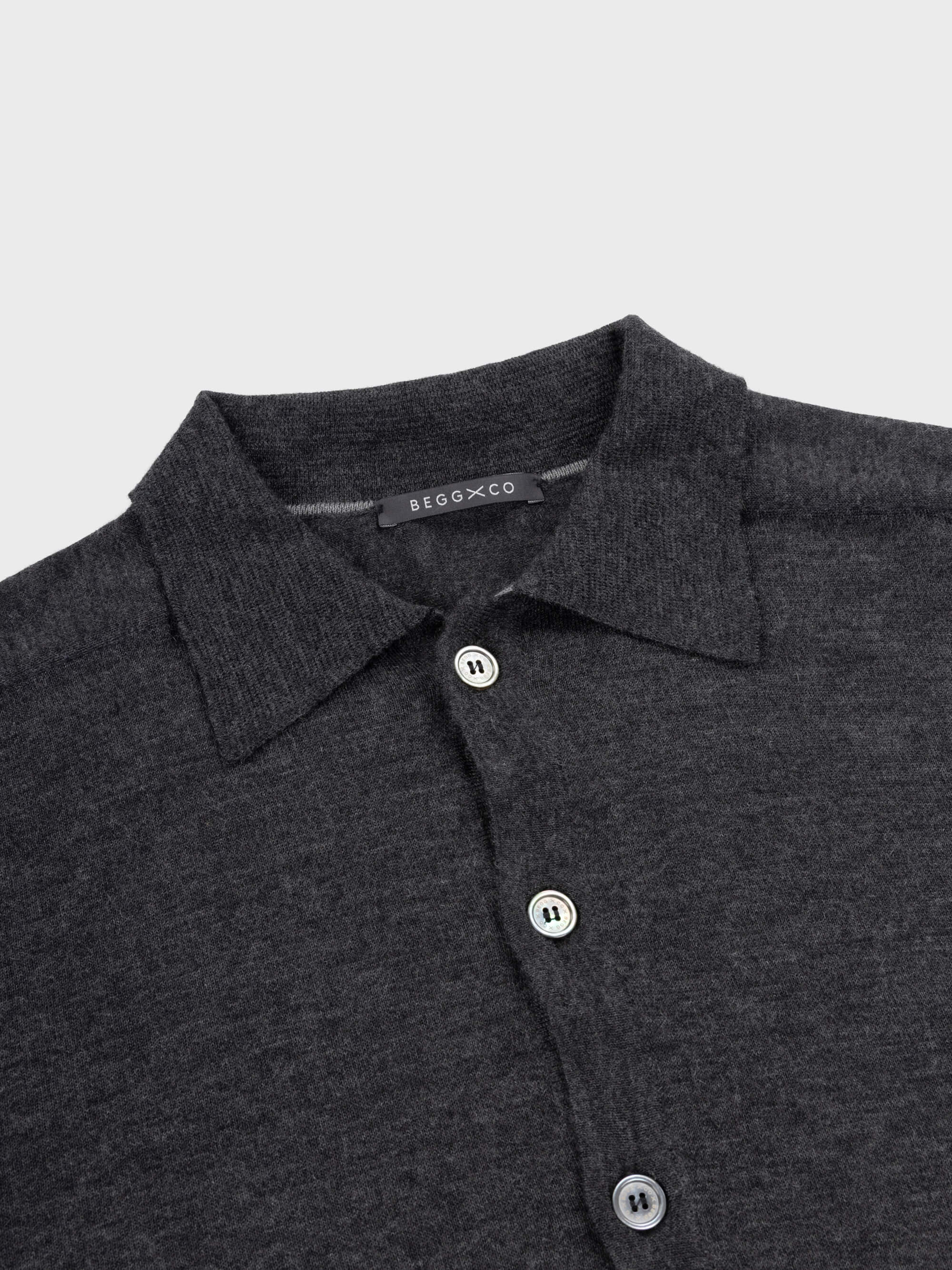 lightweight mens dark grey cashmere cardigan with collar and mother of pearl buttons on a grey background