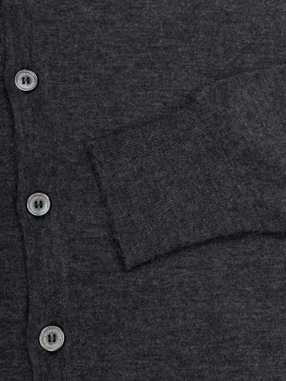 lightweight mens dark grey cashmere cardigan with collar and mother of pearl buttons and ribbed cuff detail on a grey background